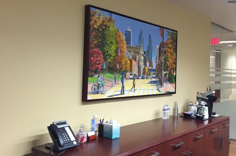 The conference room at Drucker & Scaccetti's Center City office features a painting of Drexel's campus. Employees of all levels, including interns, are Drexel Dragons.